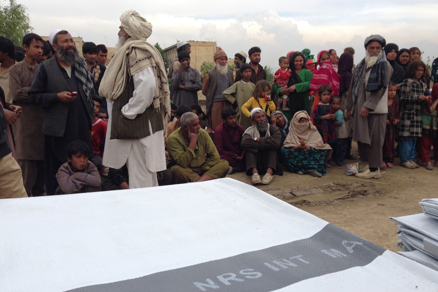 distributing tarpaulins in Afghanistan