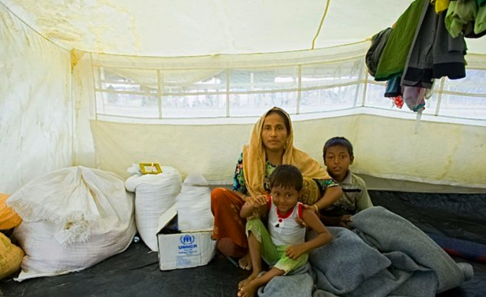 LoveCoats winter campaignRohingya refugee family keeping warm inside the tent