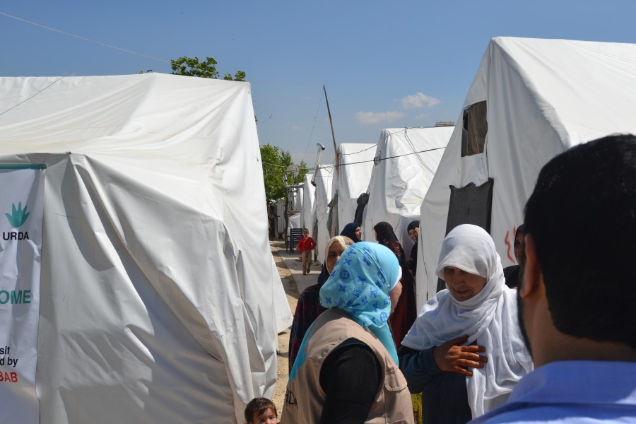 refugee women stands together at Lebanon camp in 2017
